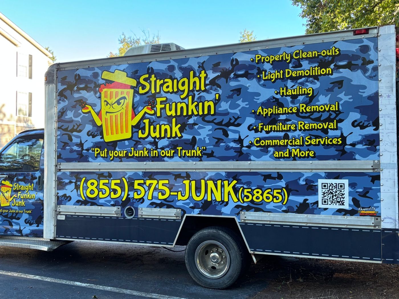 Side of the Straight Funkin' Junk truck listing property clean-outs, light demolition, hauling, appliance and furniture removal